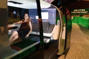 A WOMAN LOUNGES IN AN AUTONOMOUS CAR 