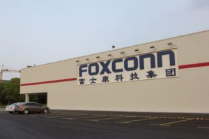 A WAREHOUSE WALL BEARS A FOXCONN LOGO