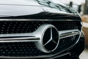 A close-up can be seen of the Mercedes Benz logo on a new black Mercedes-Benz SLC. Photo: iStock.com/franz12