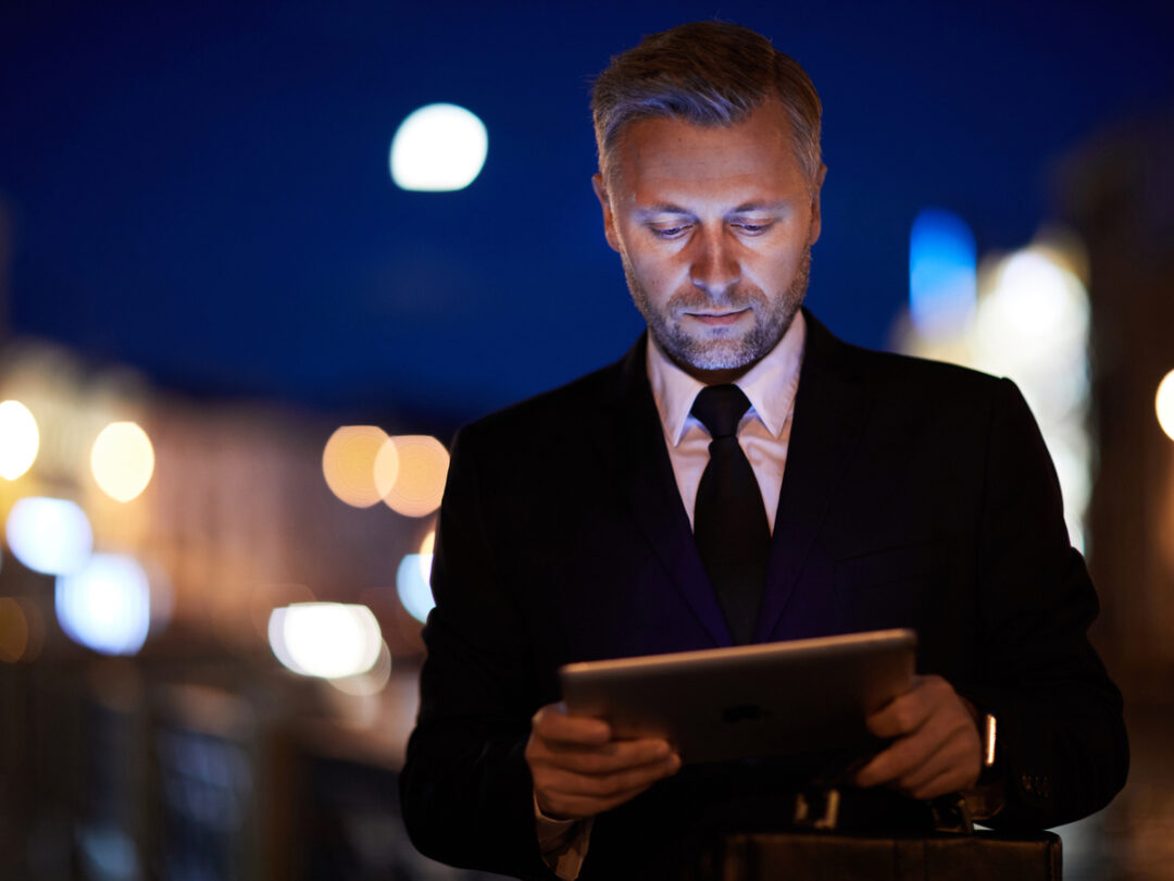 PHOTO OF A MAN LOOKING AT A TABLET