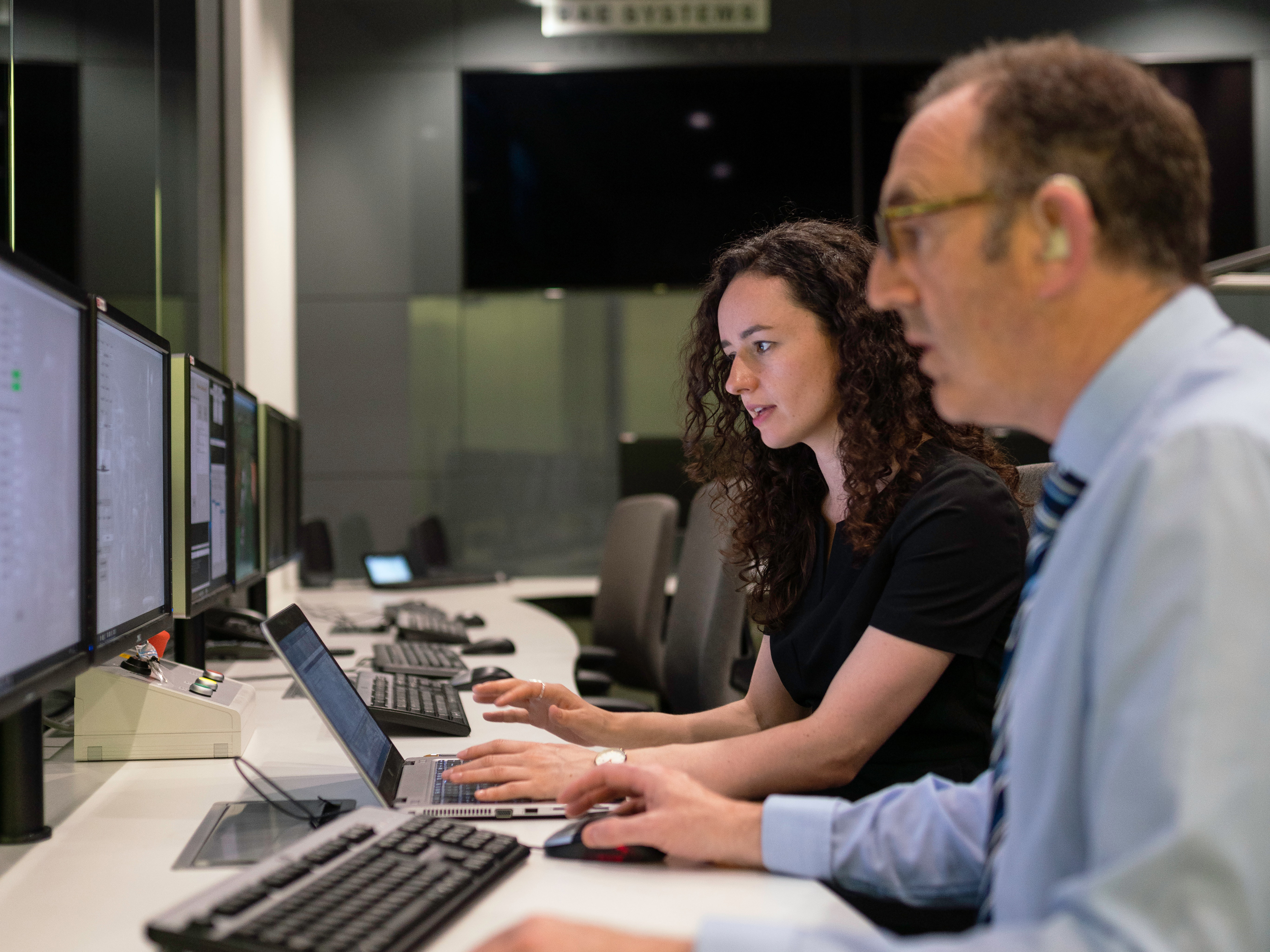 Two colleagues view data on computer screens. Photo: Pexels