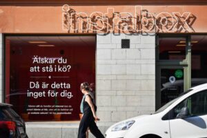 Photo of people walking past an Instabox storefront Bloomberg