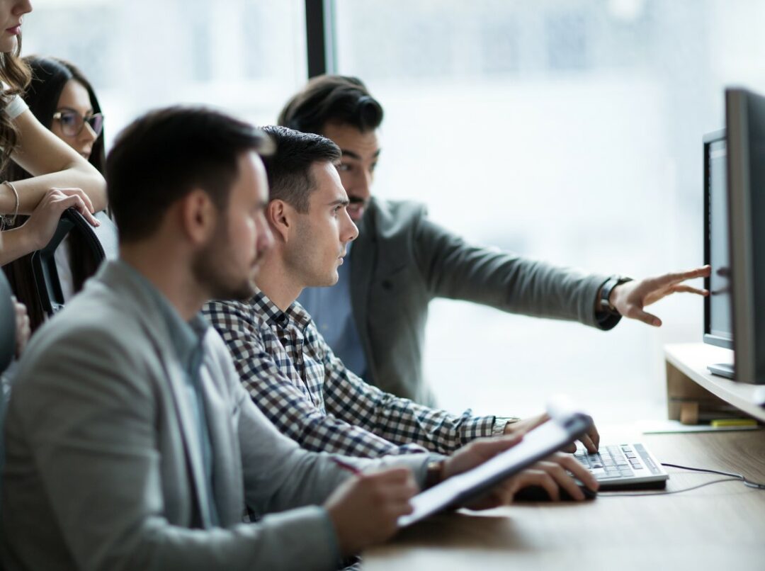 MULTIPLE TRAINEES SIT AT A COMPUTER SCREEN iStock-nd3000-1035518406.jpg