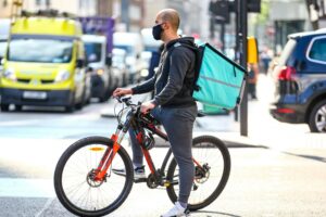 A DELIVERY PERSON ON A BICYCLE