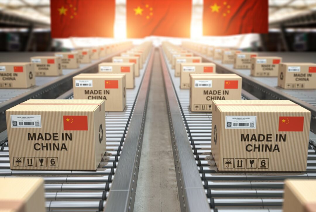 BOXES STAMPED MADE IN CHINA ROLL ALONG A CONVEYOR IN A CHINESE FACTORY