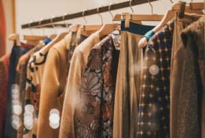 A RACK HUNG WITH A COLLECTION OF FASHION CLOTHING 