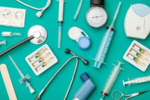 AN ARRAY OF MEDICAL DEVICES LAID OUT ON A GREEN BACKGROUND