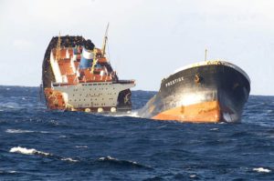 AN OIL TANKER, BROKEN IN HALF, SINKS IN ROILING SEAS