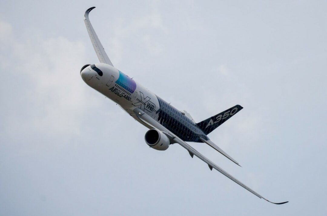 A WIDE-BODY AIRCRAFT FLIES THROUGH THE SKY