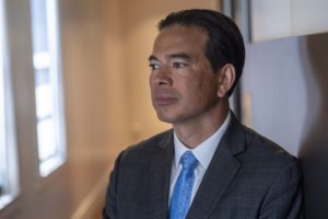 HEADSHOT OF A MAN IN A JACKET AND TIE