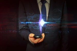 A MAN IN A SUIT HOLDS A PHONE WITH A GRAPHIC OF THIN BLUE LINES HOVERING OVER IT