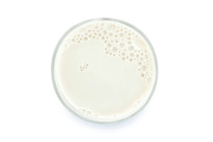 An aerial view of a glass of milk in front of a white background. Photo: iStock.com/SmileStudioAP