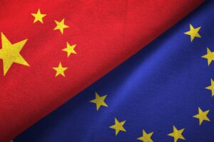 THE FLAGS OF CHINA AND THE EU ARE FOLDED NEXT TO ONE ANOTHER