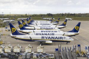 MULTIPLE PLANES BEARING THE RYANAIR LOGO SIT ON AN AIRPORT TARMAC