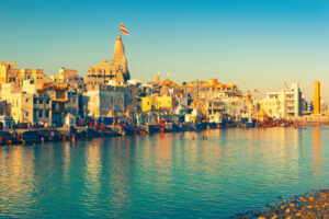 THE LANDSCAPE OF DWARKA, GUJARAT, INDIA CAN BE SEEN ON THE WATER DURING DAYTIME. 