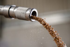 GRAINS OF WHEAT SHOOT OUT OF A SAMPLE TUBE IN A HUNGARY-BASED STORAGE GRANARY.