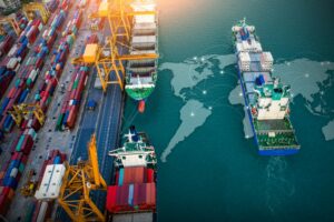 SHIPS DOCK AT A LARGE PORT, A MAP OF THE WORLD EMBEDDED IN THE SEA