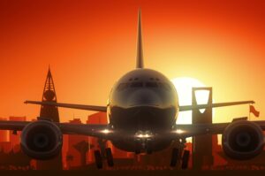 A LARGE PLANE TAKES OFF AGAINST A SUNSET-LIT SKYLINE.