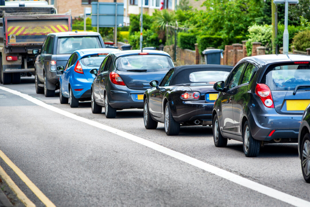 A HEAVY TRAFFIC JAM TAKES PLACE NEXT TO A BUS LANE.