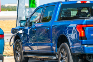 A FORD-F150-LIGHTNING-EV- CHARGES AT A STATION