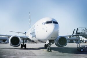 A LARGE PLANE BEARING THE ALASKA AIRLINES INSIGNIA SITS ON THE TARMAC