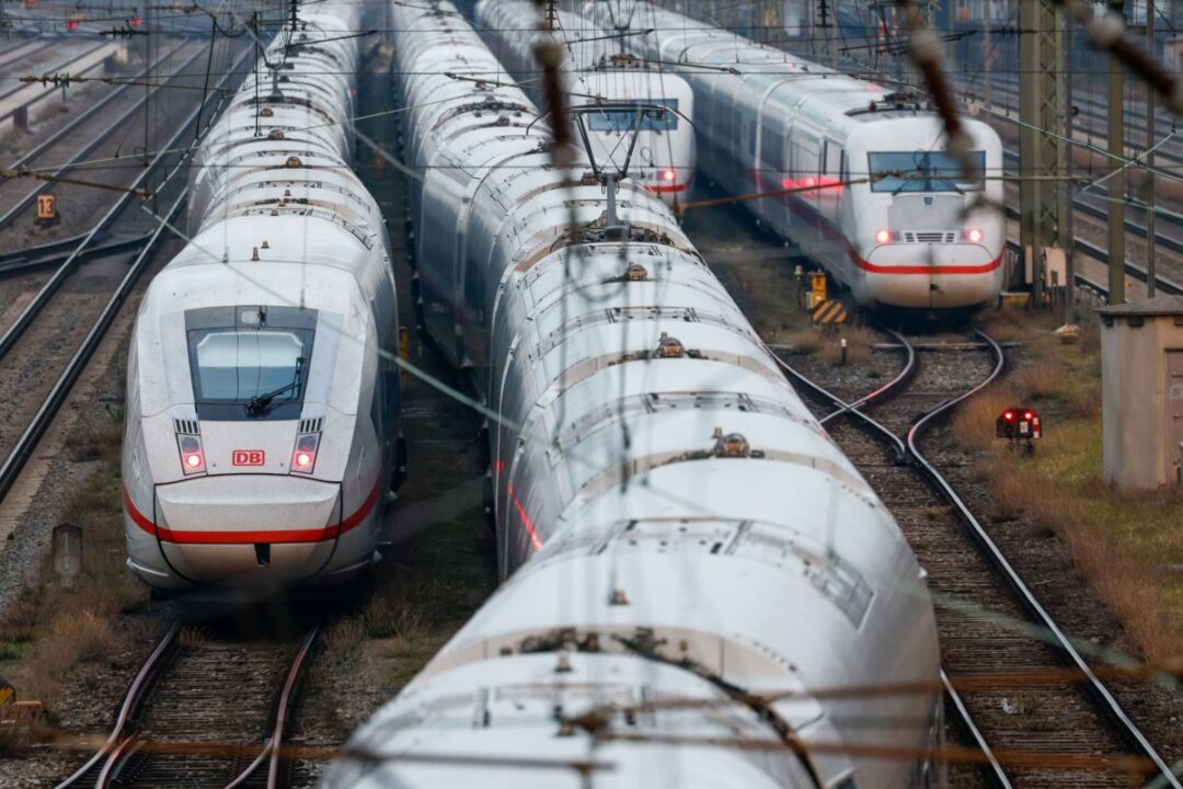 MULTIPLE TRAINS CROWD TOGETHER ON TRACKS.