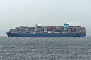 A LADEN CONTAINER VESSEL PLIES THE SEAS.