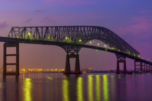 A LONG METAL BRIDGE AT NIGHT