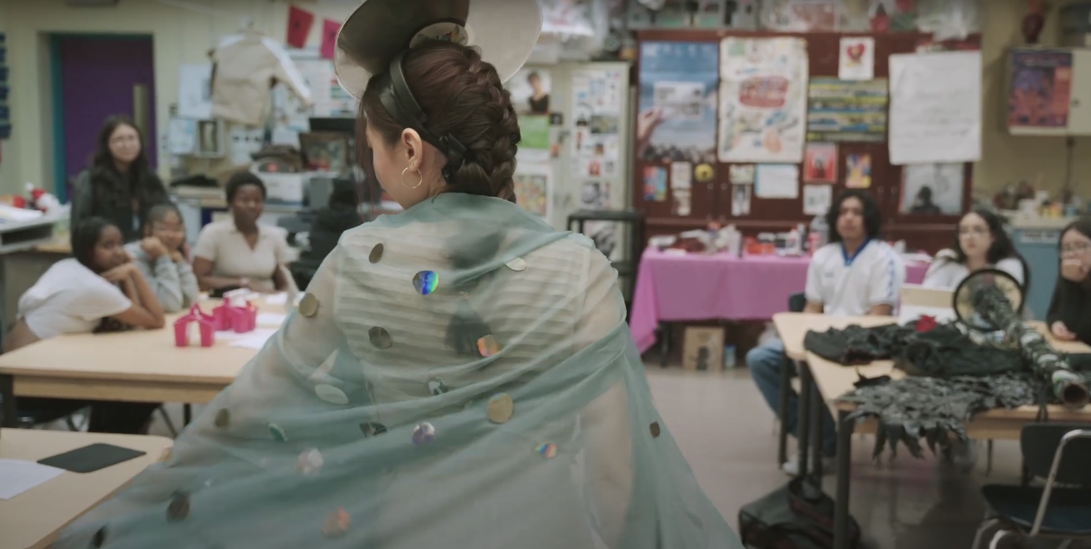 A student in a cape adorned with recycled technology