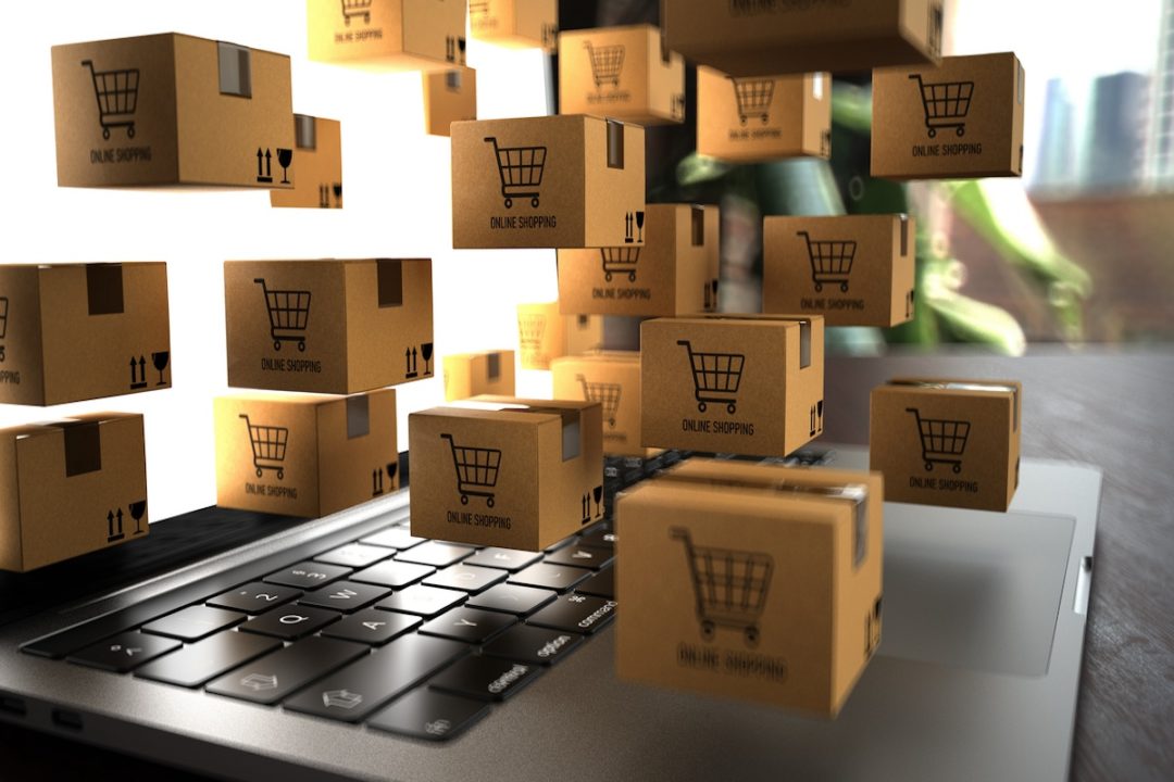 Brown cardboard boxes floating above a laptop keyboard