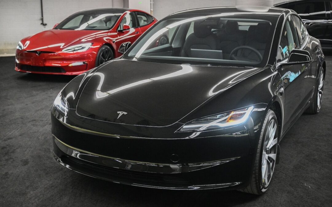 Two Tesla Model 3s on a showroom floor