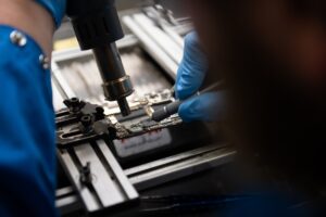 A close-up of a microchip being assembled in a factory