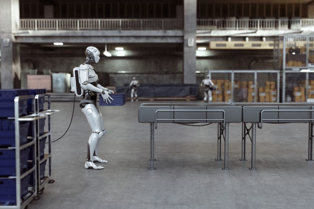 A humanoid robot next to a conveyer belt in a warehouse