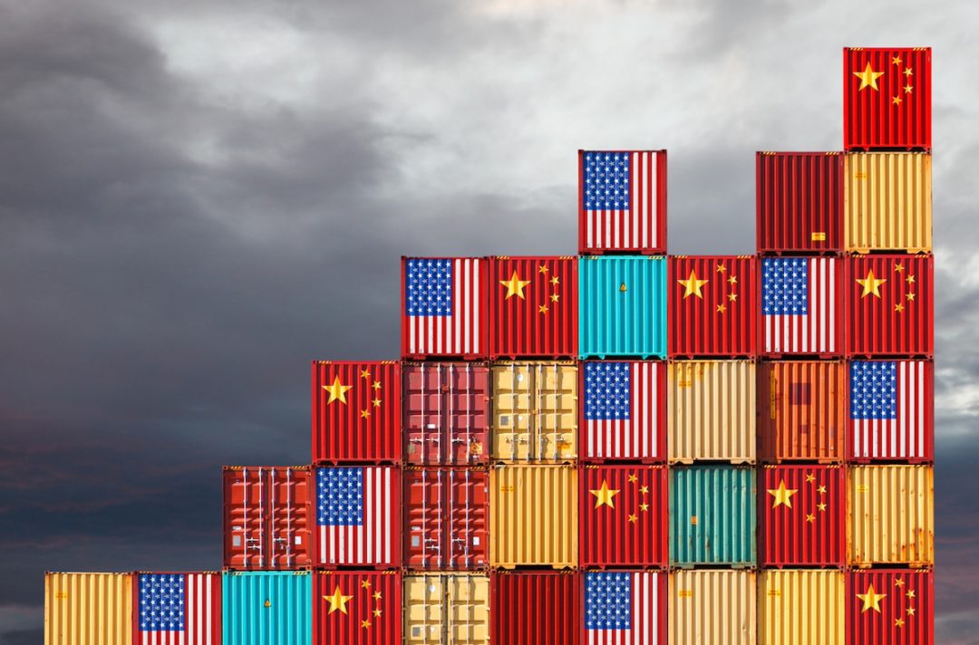 Cargo containers with Chinese and United States flags reflecting trade war and restrictions in export and import