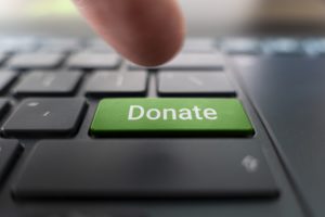 A green donation button on a keyboard