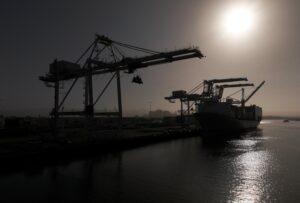 A ship docked in the Red Sea next to a crane