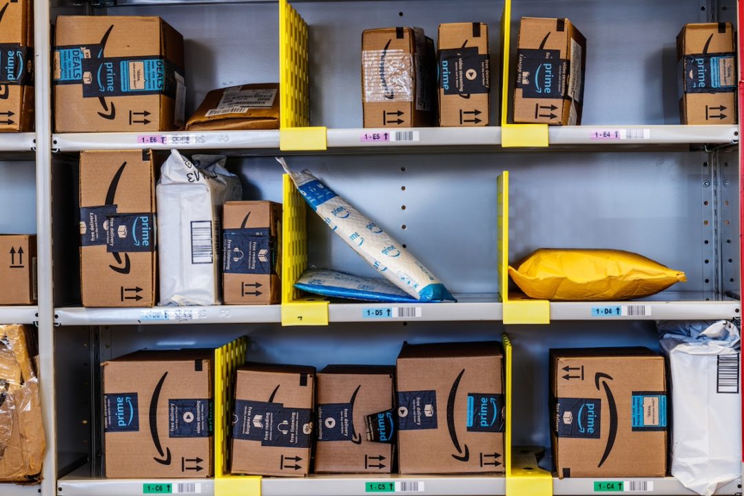 A collection of Amazon packages on three shelves