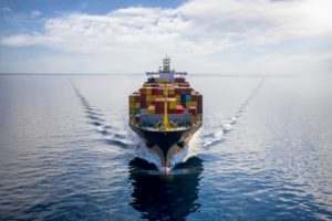A view from the front of a cargo ship loaded with containers in the ocean