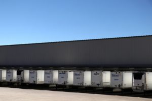 A line of semi-trucks outside of a Walmart warehouse