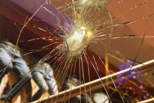 A SHATTERED STORE FRONT WITH OUT OF FOCUS GOODS VISIBLE BEHIND