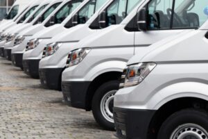 The fronts of a row of white delivery vans