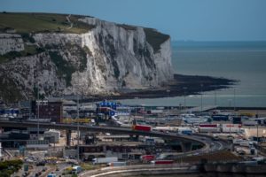 THEWHITE CLIFFS OF COVER OF ENGLAND LOOM OVER AN ILLUMINATED PORT