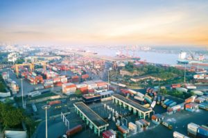 Aerial view of a bustling shipping port filled with colorful cargo containers