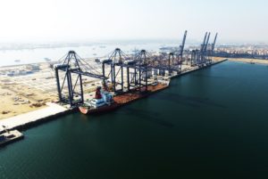 AN AERIAL VIEW OF A SEA PORT WITH GIANT CRANES