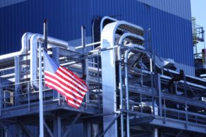 An American flag outside of an industrial building