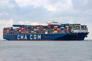 A blue container ship with "CMA CGM" written on the side in white lettering