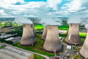 HUGE CHIMNEYS FROM A FACTORY SPOUT CLOUDS OF EMISSIONS