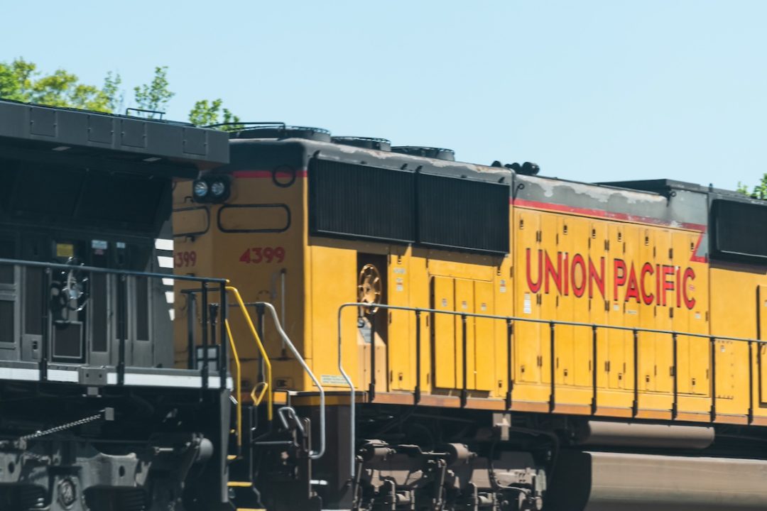 A yellow train car with "Union Pacific" written on the side in large red lettering