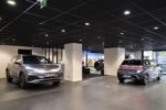 FRESHLY MINTED SUV VEHICLES SIT ON POLISHED CONCRETE IN AN UNDERGROUND GARAGE