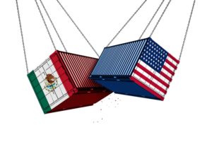 TWO SHIPPING CONTAINERS, EACH BEARING THE FLAG COLORS OF THE US AND MEXICO, SWING INTO ONE ANOTHER, DEBRIS FALLING FROM THEM